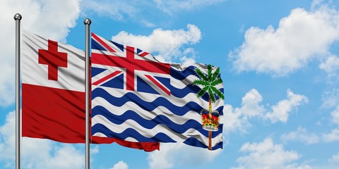 Tonga and British Indian Ocean Territory flag waving in the wind against white cloudy blue sky together. Diplomacy concept, international relations.