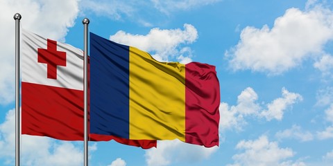 Tonga and Chad flag waving in the wind against white cloudy blue sky together. Diplomacy concept, international relations.