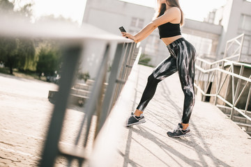 Beautiful sport fitness girl in sportswear doing fitness exercise in the street ,outdoor sports. Urban style.