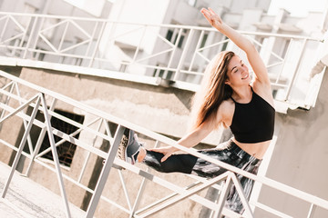 Beautiful sport fitness girl in sportswear doing fitness exercise in the street ,outdoor sports. Urban style.