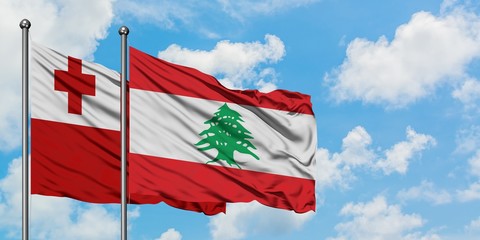 Tonga and Lebanon flag waving in the wind against white cloudy blue sky together. Diplomacy concept, international relations.