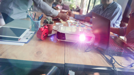 Group of Asian designers brainstorming working together with colleagues and color swatches in co-working workplace.