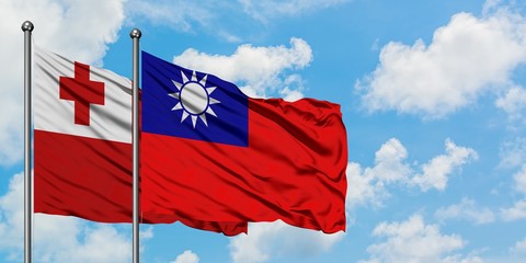 Tonga and Taiwan flag waving in the wind against white cloudy blue sky together. Diplomacy concept, international relations.