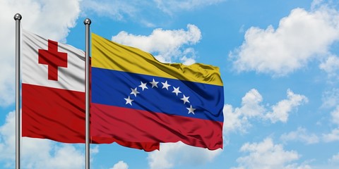 Tonga and Venezuela flag waving in the wind against white cloudy blue sky together. Diplomacy concept, international relations.
