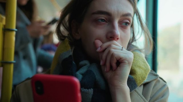 Face sick woman use phone coughs sneezes on the tram look at camera cold autumn day flu season disease fever grippe health illness infection influenza migraine sickness slow motion