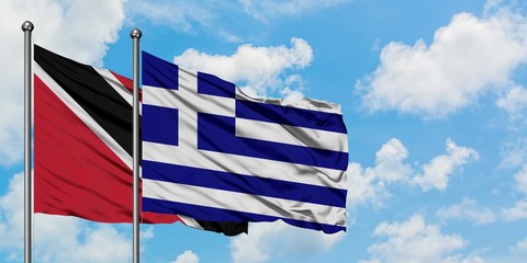 Trinidad And Tobago and Greece flag waving in the wind against white cloudy blue sky together. Diplomacy concept, international relations.