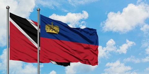 Trinidad And Tobago and Liechtenstein flag waving in the wind against white cloudy blue sky together. Diplomacy concept, international relations.