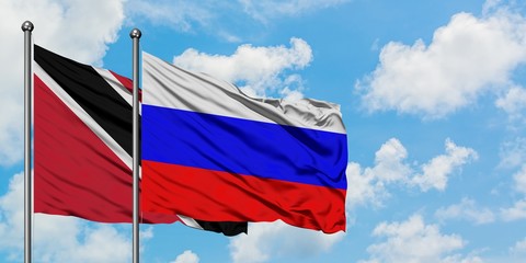 Trinidad And Tobago and Russia flag waving in the wind against white cloudy blue sky together. Diplomacy concept, international relations.