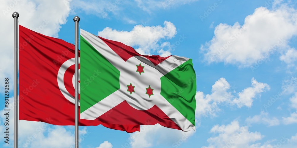 Wall mural tunisia and burundi flag waving in the wind against white cloudy blue sky together. diplomacy concep