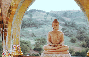 buddha image in thailand with mountain background