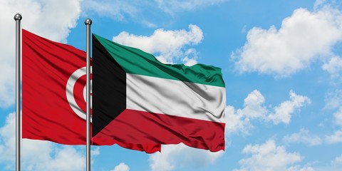 Tunisia and Kuwait flag waving in the wind against white cloudy blue sky together. Diplomacy concept, international relations.