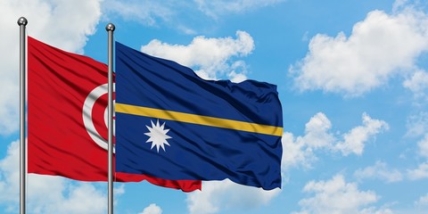 Tunisia and Nauru flag waving in the wind against white cloudy blue sky together. Diplomacy concept, international relations.