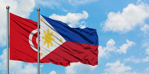 Tunisia and Philippines flag waving in the wind against white cloudy blue sky together. Diplomacy concept, international relations.