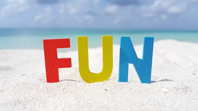 Creative Fun Word In the White Sand Beach With Blurred Background of Turquoise Sea and Cloudly Sky in Thailand  - Close Shot