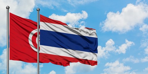Tunisia and Thailand flag waving in the wind against white cloudy blue sky together. Diplomacy concept, international relations.