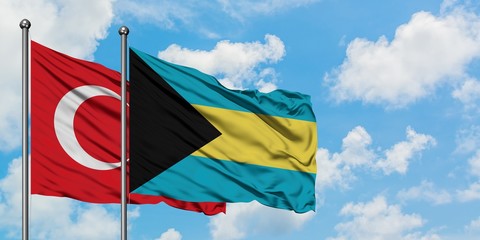 Turkey and Bahamas flag waving in the wind against white cloudy blue sky together. Diplomacy concept, international relations.