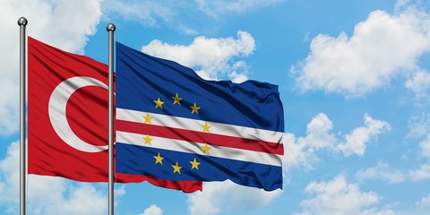 Turkey and Cape Verde flag waving in the wind against white cloudy blue sky together. Diplomacy concept, international relations.