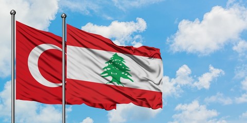 Turkey and Lebanon flag waving in the wind against white cloudy blue sky together. Diplomacy concept, international relations.
