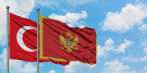 Turkey and Montenegro flag waving in the wind against white cloudy blue sky together. Diplomacy concept, international relations.