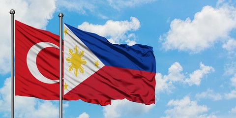 Turkey and Philippines flag waving in the wind against white cloudy blue sky together. Diplomacy concept, international relations.