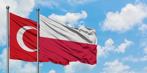 Turkey and Poland flag waving in the wind against white cloudy blue sky together. Diplomacy concept, international relations.