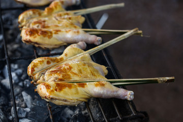 South East Asian Food. Grilled chicken. Grilled BBQ Chicken. Barbecued chicken on charcoal stove. Street food Asian