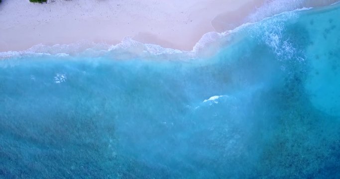 Big Green Waves Splashing Towards the White Sand in an Island of Bahamas - Aerial Shot