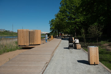 People relax in the park on a summer day.