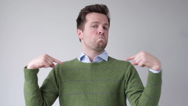 Confident, self-assured and charismatic man pointing on himself with fingers.