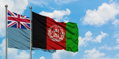 Tuvalu and Afghanistan flag waving in the wind against white cloudy blue sky together. Diplomacy concept, international relations.