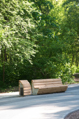 Bench with an urn in the park on a summer day.