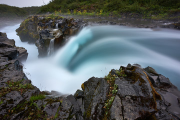 Fototapeta na wymiar Blue waterfall flow