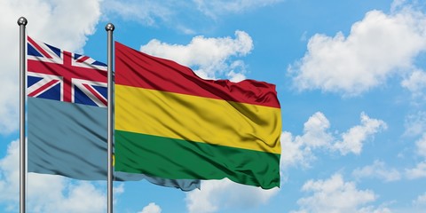 Tuvalu and Bolivia flag waving in the wind against white cloudy blue sky together. Diplomacy concept, international relations.