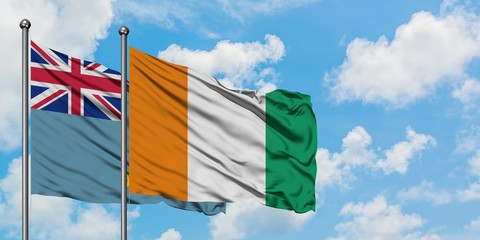 Tuvalu and Cote D'Ivoire flag waving in the wind against white cloudy blue sky together. Diplomacy concept, international relations.