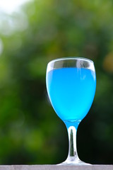 glass of cocktail on green background