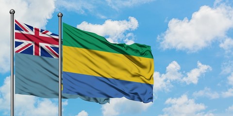 Tuvalu and Gabon flag waving in the wind against white cloudy blue sky together. Diplomacy concept,...