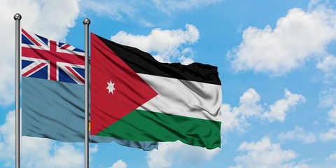 Tuvalu and Jordan flag waving in the wind against white cloudy blue sky together. Diplomacy...