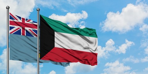 Tuvalu and Kuwait flag waving in the wind against white cloudy blue sky together. Diplomacy concept, international relations.