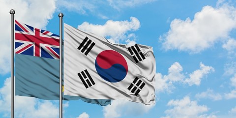 Obraz premium Tuvalu and South Korea flag waving in the wind against white cloudy blue sky together. Diplomacy concept, international relations.