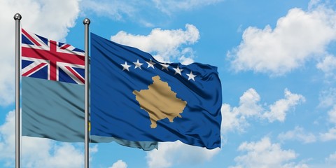 Tuvalu and Kosovo flag waving in the wind against white cloudy blue sky together. Diplomacy concept, international relations.