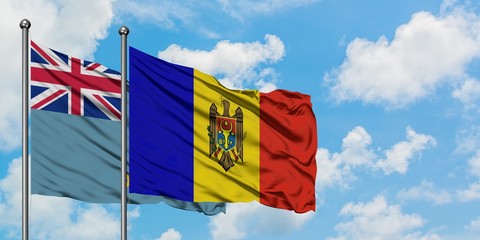 Tuvalu and Moldova flag waving in the wind against white cloudy blue sky together. Diplomacy concept, international relations.