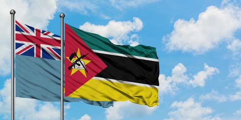 Tuvalu and Mozambique flag waving in the wind against white cloudy blue sky together. Diplomacy...