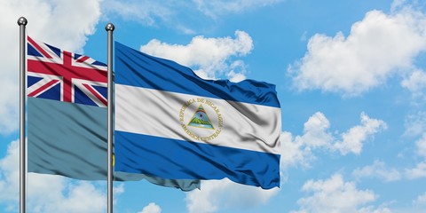 Tuvalu and Nicaragua flag waving in the wind against white cloudy blue sky together. Diplomacy...