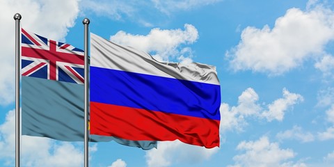 Tuvalu and Russia flag waving in the wind against white cloudy blue sky together. Diplomacy concept, international relations.