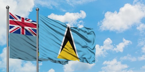 Tuvalu and Saint Lucia flag waving in the wind against white cloudy blue sky together. Diplomacy...