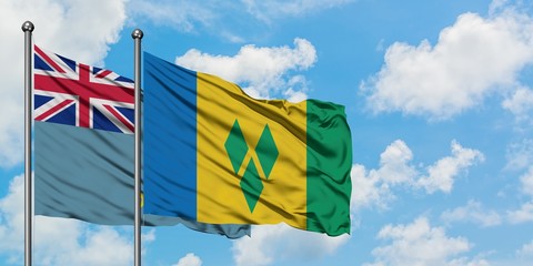Tuvalu and Saint Vincent And The Grenadines flag waving in the wind against white cloudy blue sky...