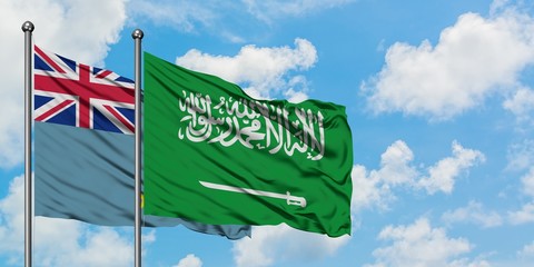 Tuvalu and Saudi Arabia flag waving in the wind against white cloudy blue sky together. Diplomacy...