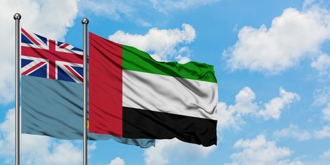 Tuvalu and United Arab Emirates flag waving in the wind against white cloudy blue sky together. Diplomacy concept, international relations.