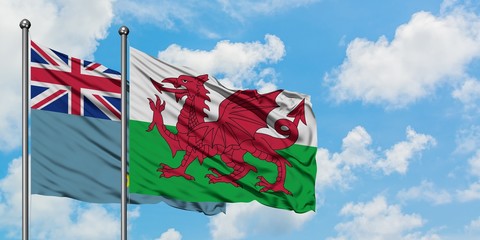 Tuvalu and Wales flag waving in the wind against white cloudy blue sky together. Diplomacy concept,...