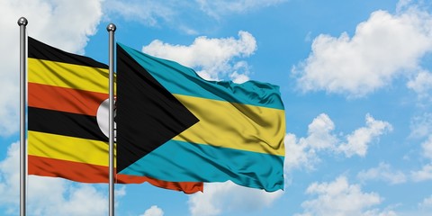Uganda and Bahamas flag waving in the wind against white cloudy blue sky together. Diplomacy concept, international relations.